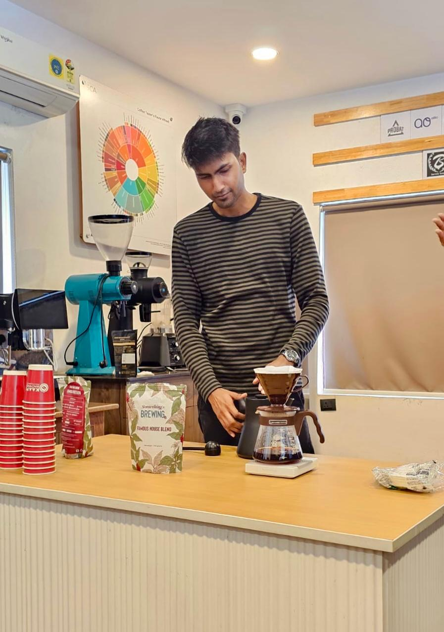 Stylized blue and pink image of a whiskey glass with the wordmark of Vèloce in pink all-caps letters above.